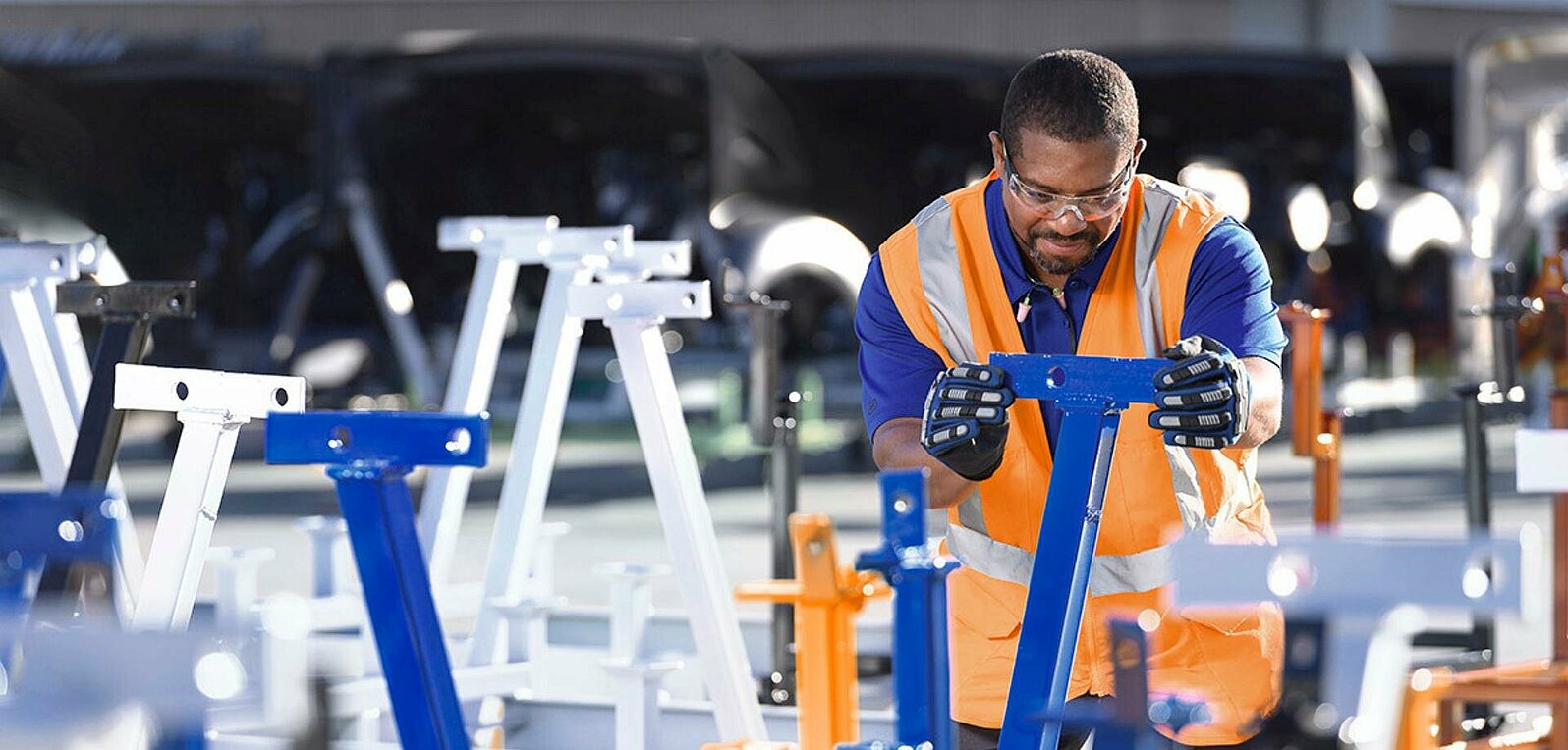 Leadec employee inspecting welding rack. 