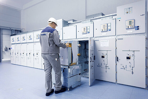 A Leadec employee installing a switchgear in a technical room. 