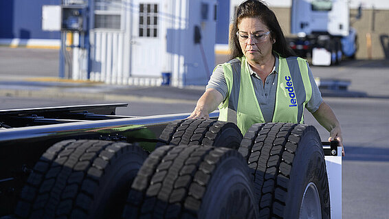 Female Leadec employee checking tyres. 